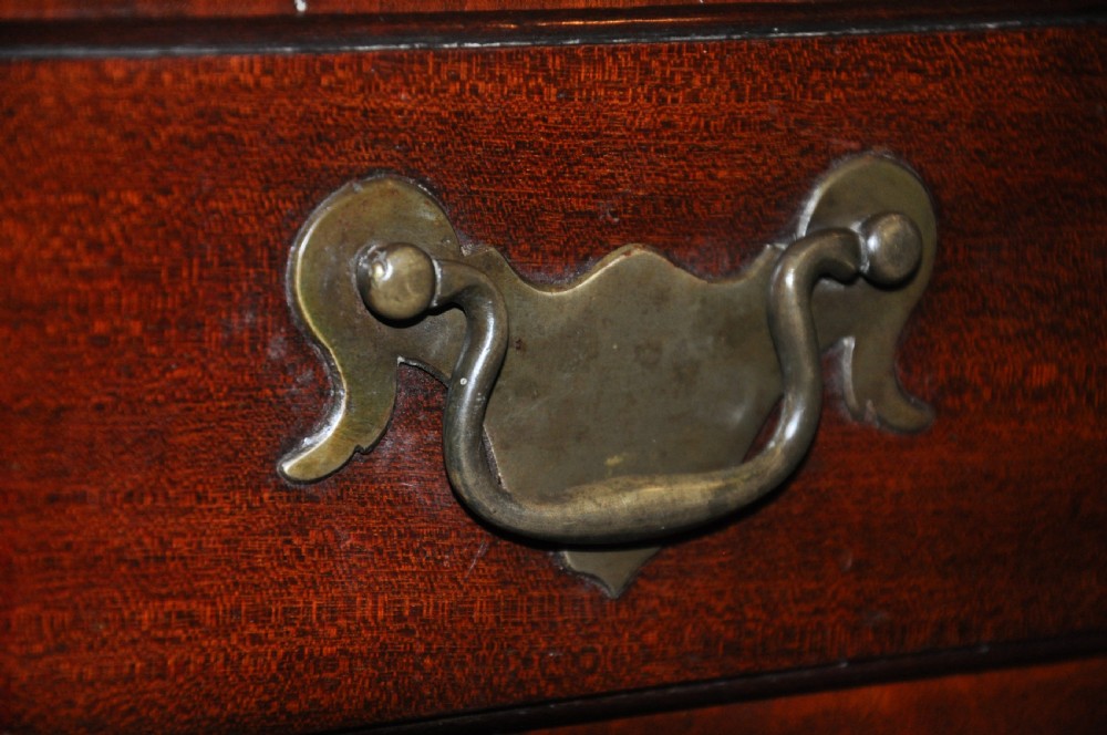 An 18th-century Georgian mahogany kneehole desk featuring six small drawers, one long top drawer, a central recessed cupboard, and brass handles on bracket feet. View III