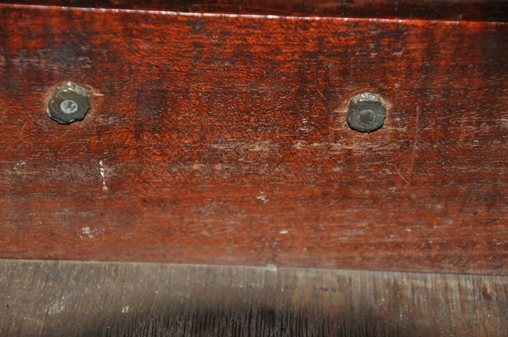 An 18th-century Georgian mahogany kneehole desk featuring six small drawers, one long top drawer, a central recessed cupboard, and brass handles on bracket feet. View VI