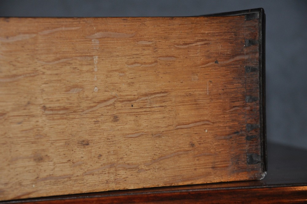 An 18th-century Georgian mahogany kneehole desk featuring six small drawers, one long top drawer, a central recessed cupboard, and brass handles on bracket feet. View VIII