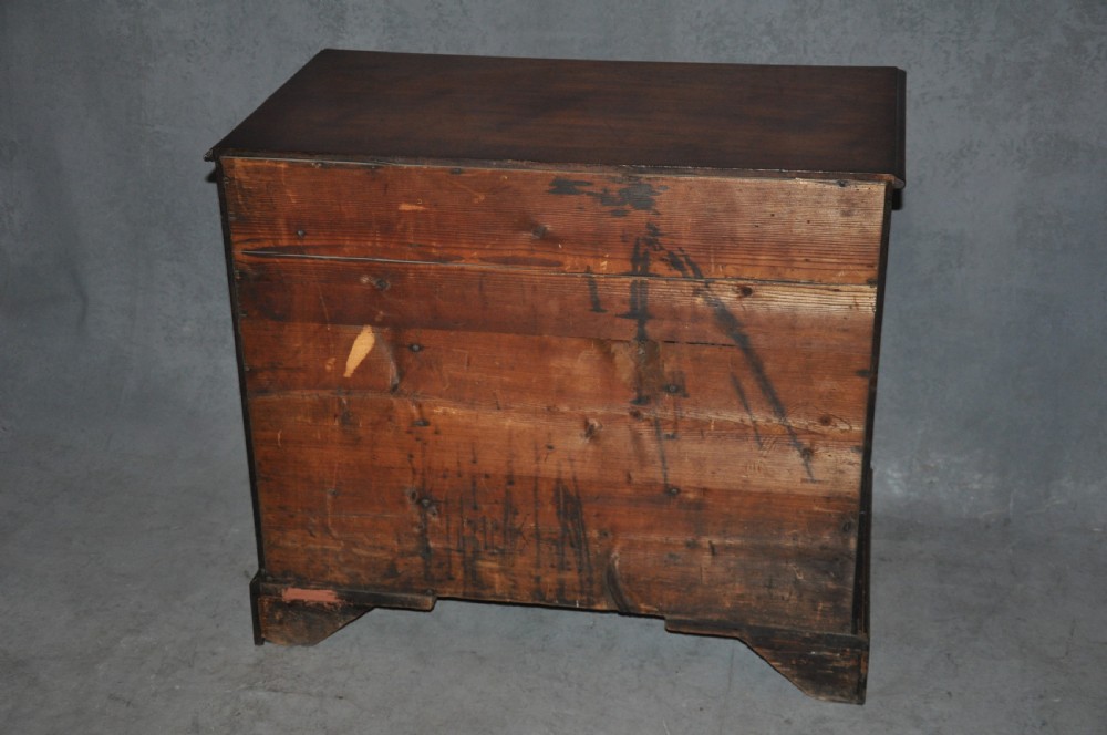 An 18th-century Georgian mahogany kneehole desk featuring six small drawers, one long top drawer, a central recessed cupboard, and brass handles on bracket feet. View IX