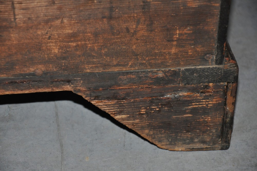 An 18th-century Georgian mahogany kneehole desk featuring six small drawers, one long top drawer, a central recessed cupboard, and brass handles on bracket feet. View X