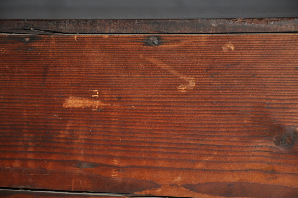An 18th-century Georgian mahogany kneehole desk featuring six small drawers, one long top drawer, a central recessed cupboard, and brass handles on bracket feet. View XI