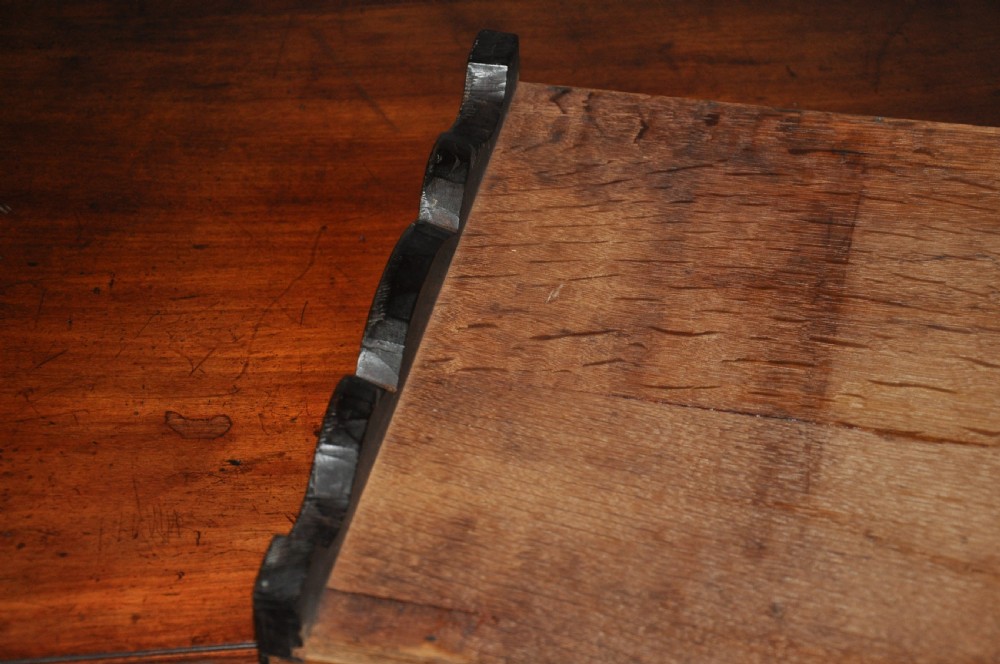 An 18th-century Georgian mahogany kneehole desk featuring six small drawers, one long top drawer, a central recessed cupboard, and brass handles on bracket feet. View XIV