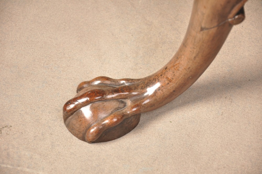 An 18th-century mahogany tilt-top tripod table shown with its circular surface locked vertically, revealing a spiral-carved pedestal and cabriole legs ending in claw and ball feet. View III