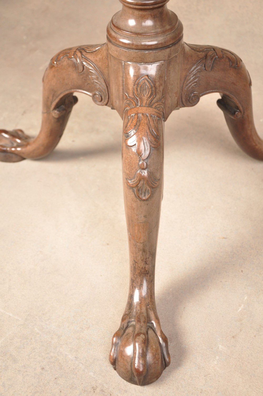 An 18th-century mahogany tilt-top tripod table shown with its circular surface locked vertically, revealing a spiral-carved pedestal and cabriole legs ending in claw and ball feet. View VI