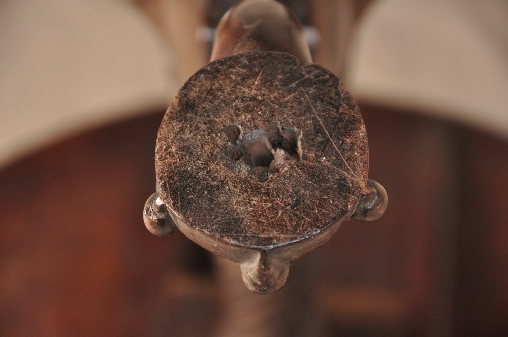 An 18th-century mahogany tilt-top tripod table shown with its circular surface locked vertically, revealing a spiral-carved pedestal and cabriole legs ending in claw and ball feet. View XI