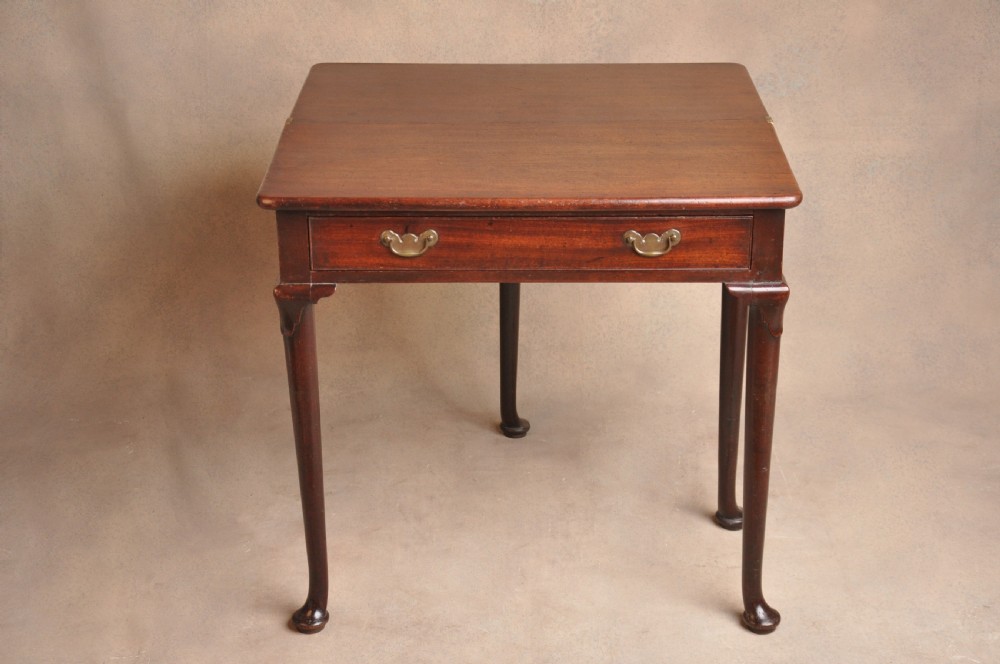 A mid-18th-century mahogany fold-over tea table featuring a single frieze drawer with brass handles and slender cabriole legs ending in pad feet. View III
