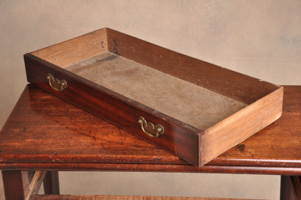 A mid-18th-century mahogany fold-over tea table featuring a single frieze drawer with brass handles and slender cabriole legs ending in pad feet. View V