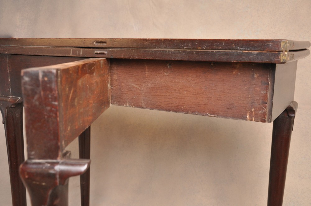 A mid-18th-century mahogany fold-over tea table featuring a single frieze drawer with brass handles and slender cabriole legs ending in pad feet. View VIII
