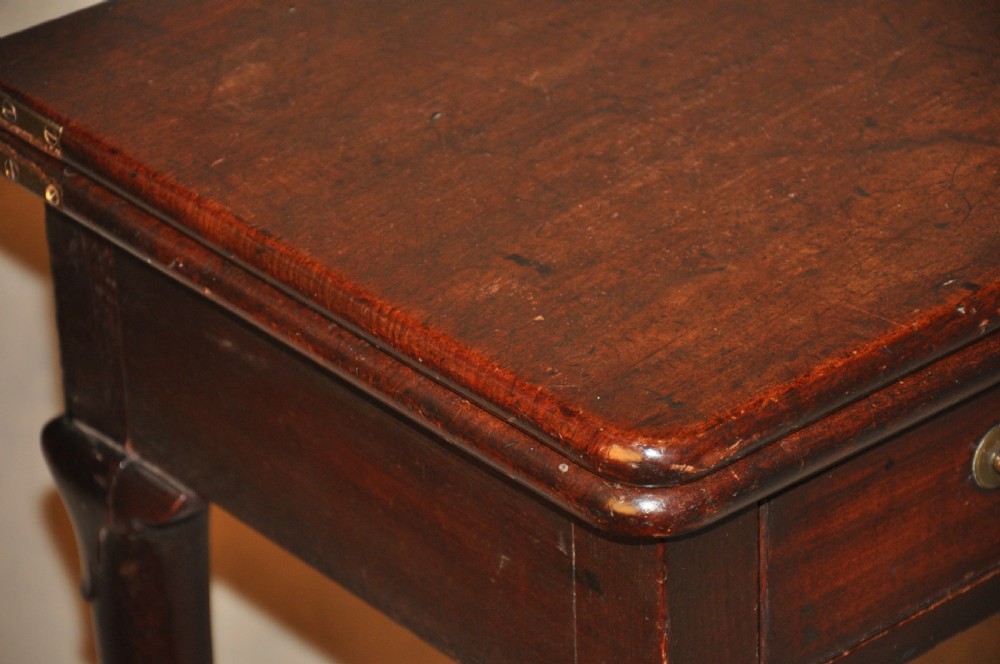 A mid-18th-century mahogany fold-over tea table featuring a single frieze drawer with brass handles and slender cabriole legs ending in pad feet. View IX