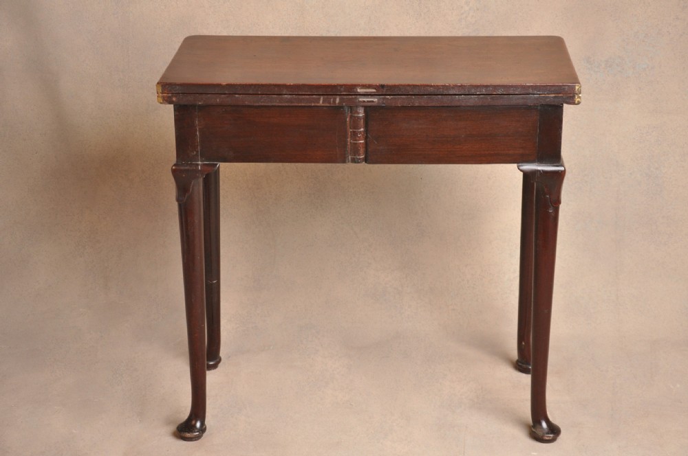 A mid-18th-century mahogany fold-over tea table featuring a single frieze drawer with brass handles and slender cabriole legs ending in pad feet. View XII