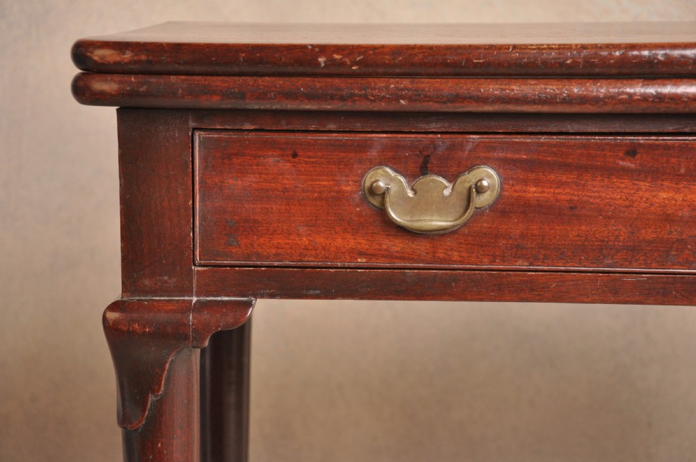 A mid-18th-century mahogany fold-over tea table featuring a single frieze drawer with brass handles and slender cabriole legs ending in pad feet. View XIV