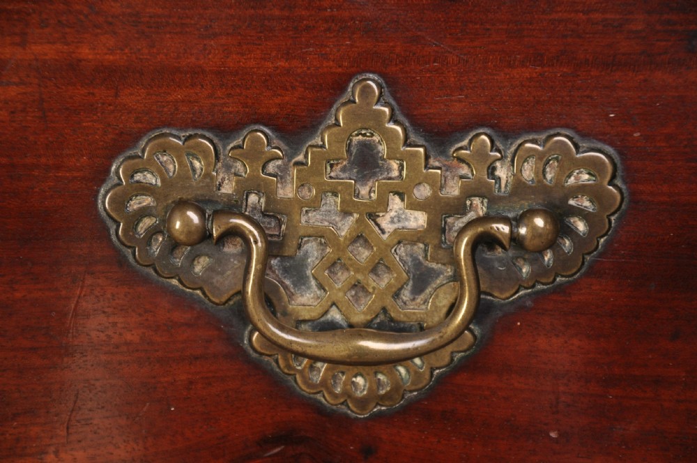 An 18th-century mahogany tallboy featuring two sections of graduated drawers, brass handles, carved blind fretwork frieze, and ogee bracket feet. View II