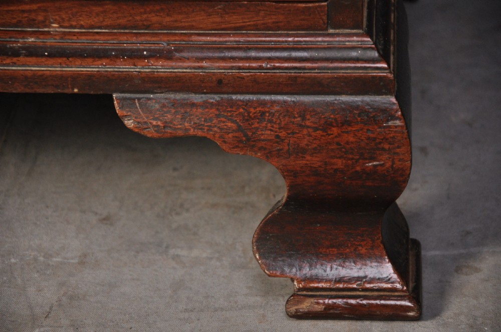 An 18th-century mahogany tallboy featuring two sections of graduated drawers, brass handles, carved blind fretwork frieze, and ogee bracket feet. View III
