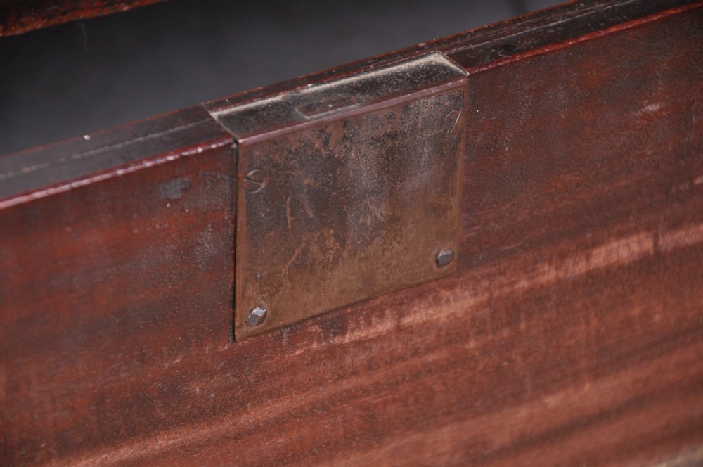 An 18th-century mahogany tallboy featuring two sections of graduated drawers, brass handles, carved blind fretwork frieze, and ogee bracket feet. View VI