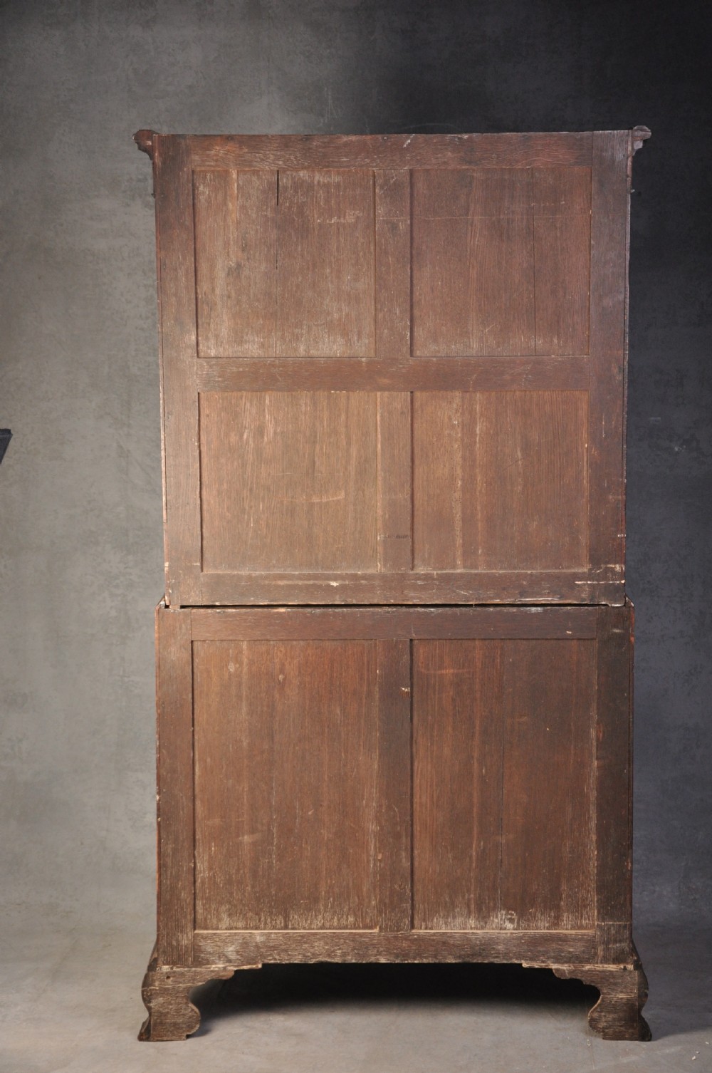 An 18th-century mahogany tallboy featuring two sections of graduated drawers, brass handles, carved blind fretwork frieze, and ogee bracket feet. View IX