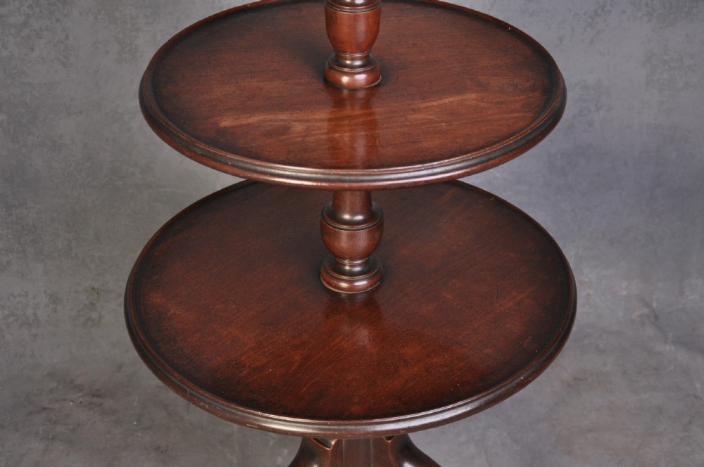 An 18th-century dark mahogany dumb waiter featuring three graduated circular dish trays supported by a turned central column on tripod cabriole legs. View IV