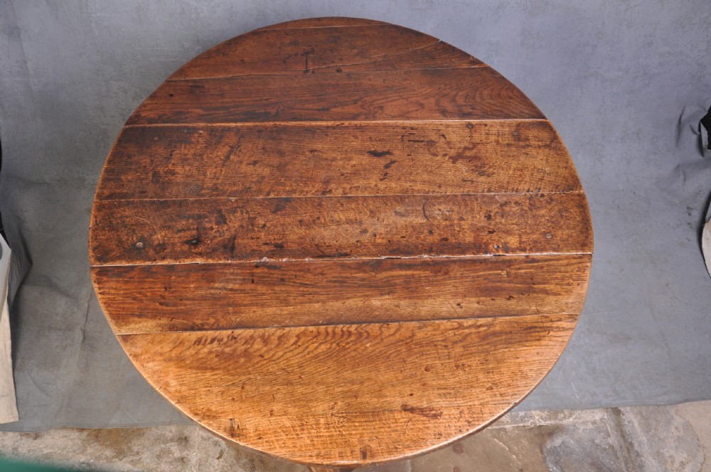 A seventeenth-century oak gateleg table shown with drop leaves folded down, featuring turned legs and low box stretchers. View III