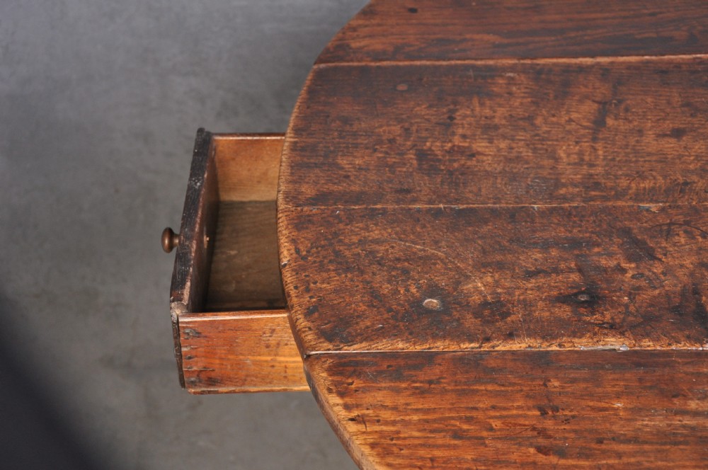 A seventeenth-century oak gateleg table shown with drop leaves folded down, featuring turned legs and low box stretchers. View VI