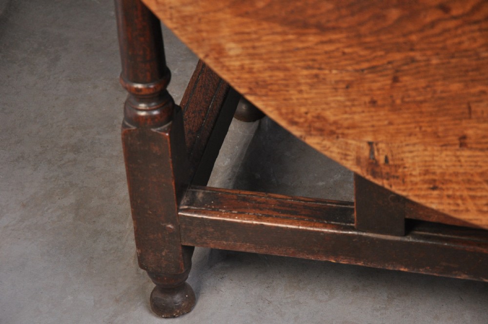 A seventeenth-century oak gateleg table shown with drop leaves folded down, featuring turned legs and low box stretchers. View VIII