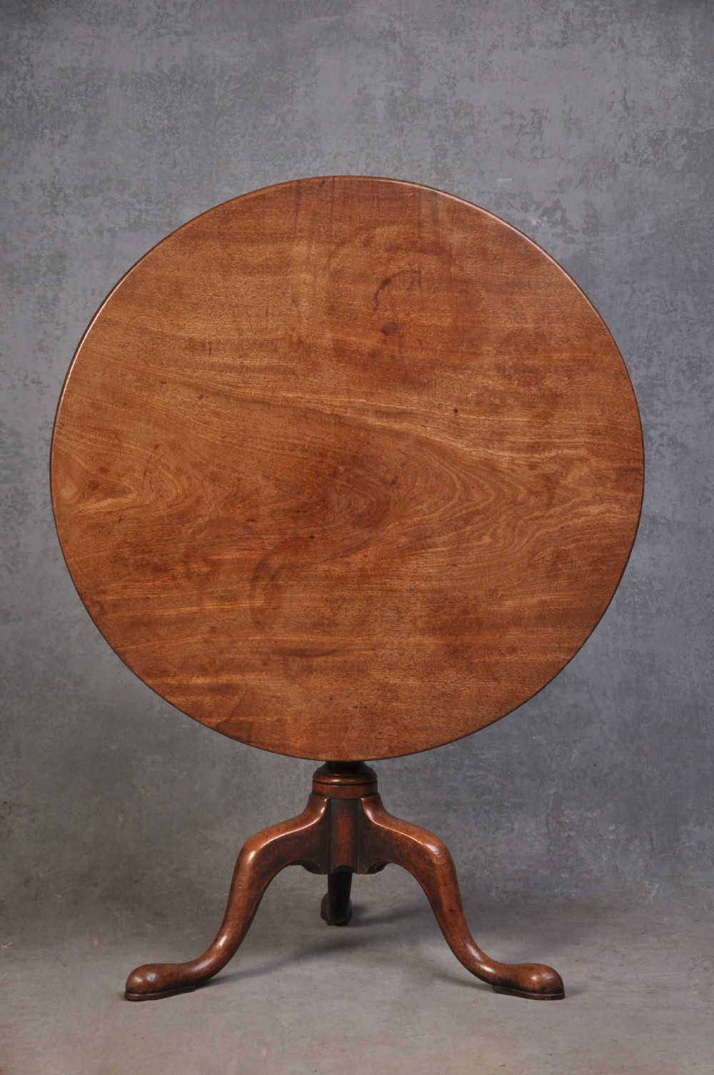 An 18th-century mahogany tripod table featuring a circular top resting on a turned column with a spiral carved knop and three cabriole legs terminating in pad feet. View II