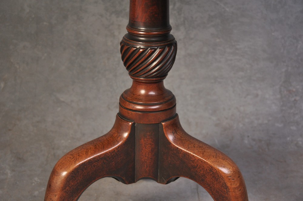 An 18th-century mahogany tripod table featuring a circular top resting on a turned column with a spiral carved knop and three cabriole legs terminating in pad feet. View IV