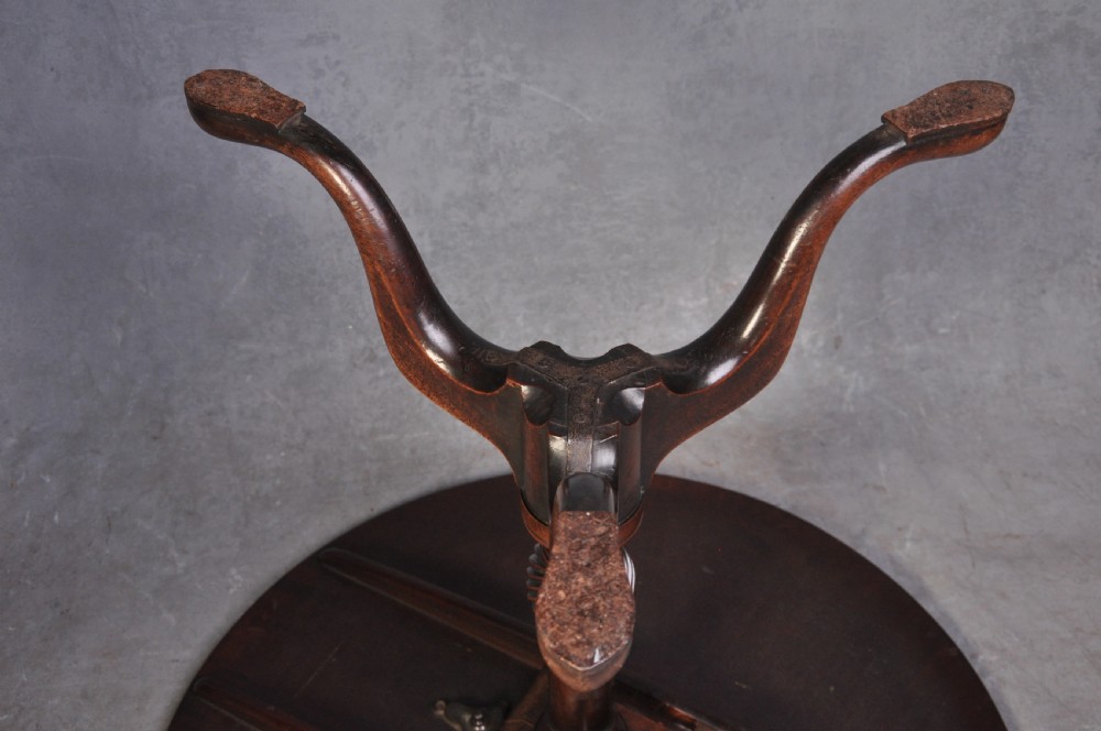 An 18th-century mahogany tripod table featuring a circular top resting on a turned column with a spiral carved knop and three cabriole legs terminating in pad feet. View VIII