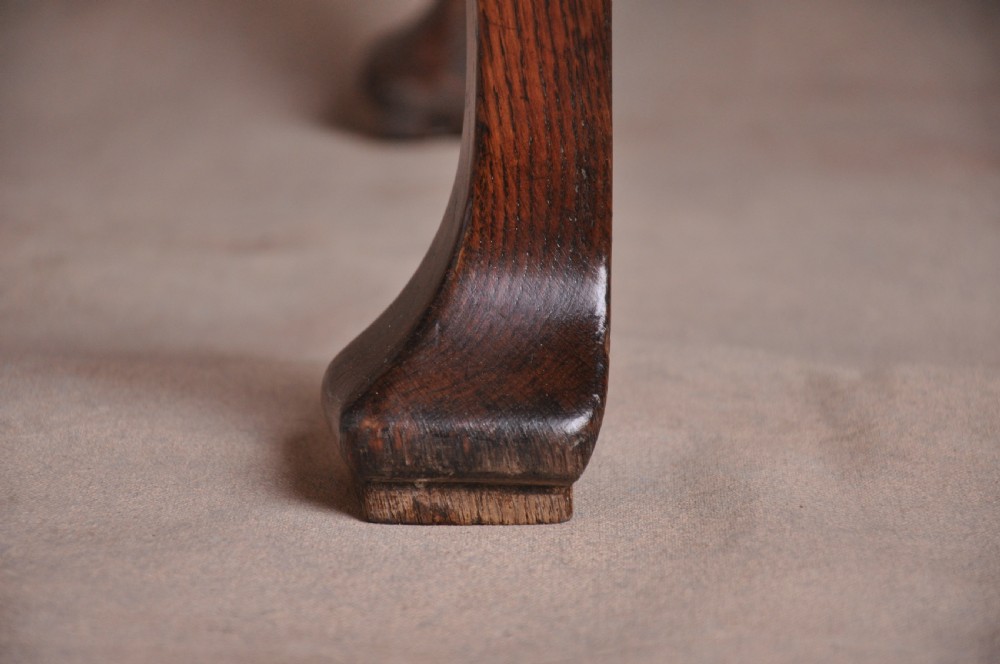 An 18th-century George I oak lowboy featuring three drawers with brass backplate handles, a shaped apron, and four cabriole legs. View III