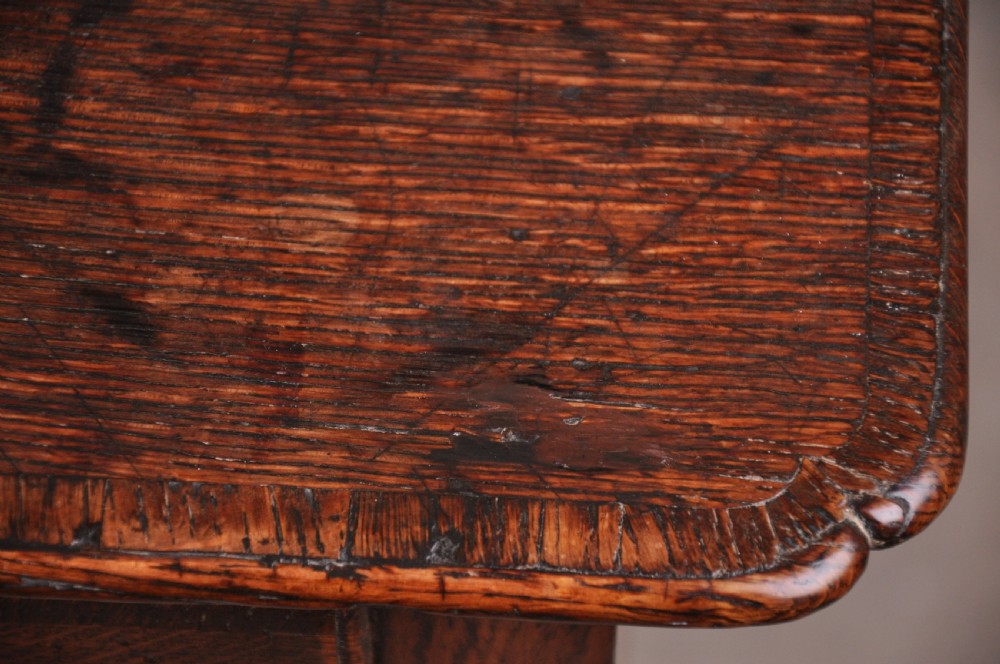 An 18th-century George I oak lowboy featuring three drawers with brass backplate handles, a shaped apron, and four cabriole legs. View VIII