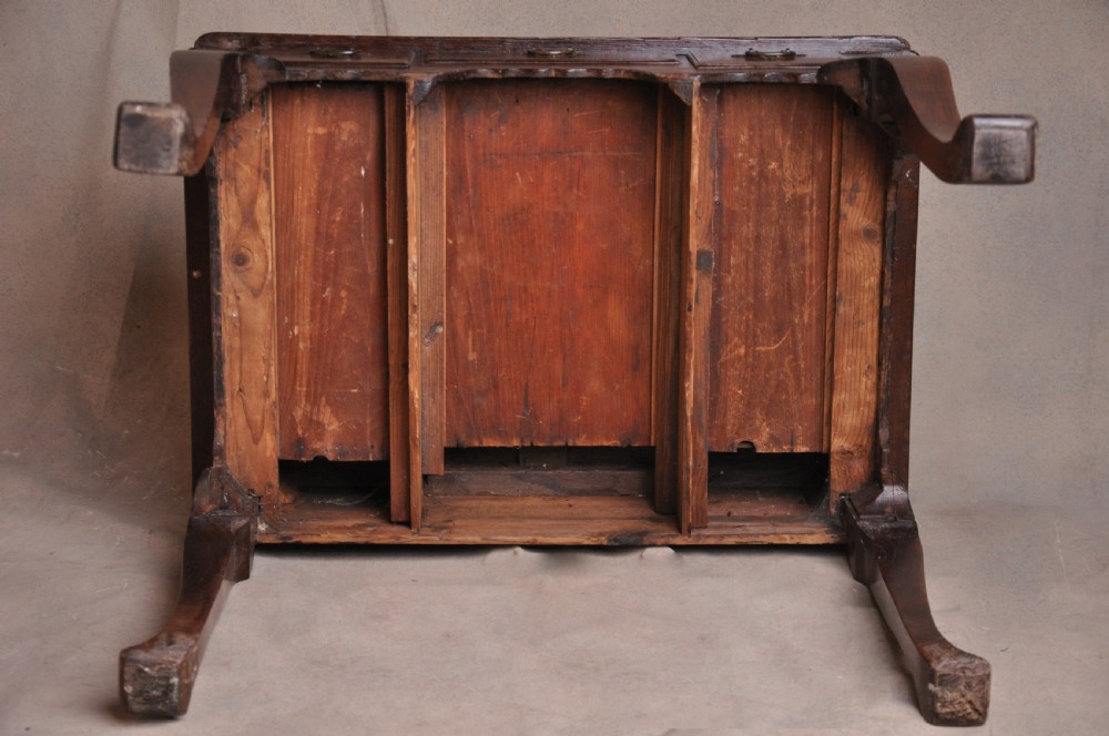 An 18th-century George I oak lowboy featuring three drawers with brass backplate handles, a shaped apron, and four cabriole legs. View IX
