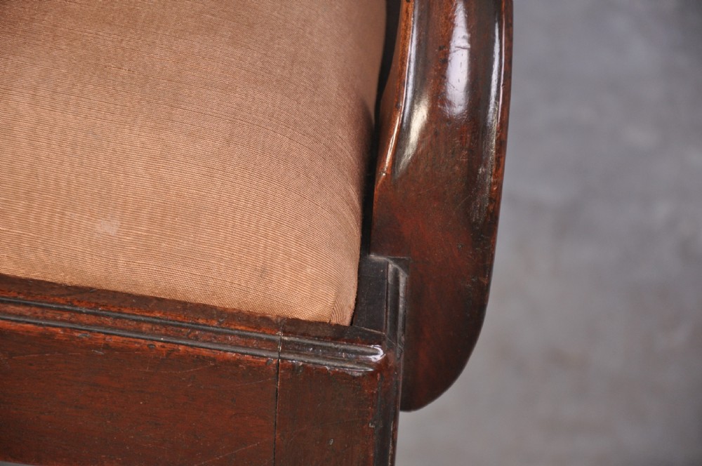 An 18th-century Hepplewhite style mahogany armchair featuring a carved pierced splat, shaped arms, square legs with stretchers, and a beige upholstered seat. View III