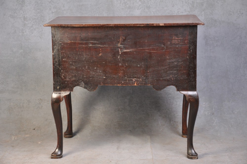An 18th-century oak lowboy table featuring three inlaid drawers, brass swan-neck handles, an arched apron, and cabriole legs. View IX