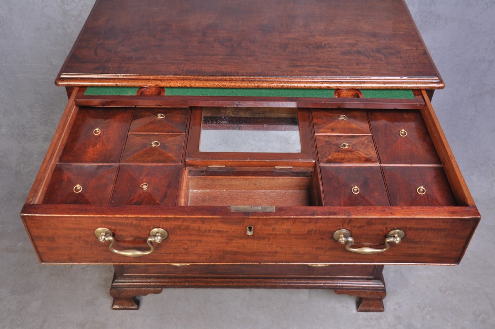 An 18th-century mahogany dressing chest featuring four graduated drawers with brass swan-neck handles and bracket feet. View IV