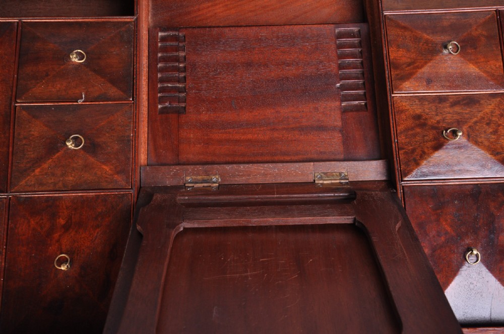 An 18th-century mahogany dressing chest featuring four graduated drawers with brass swan-neck handles and bracket feet. View VIII