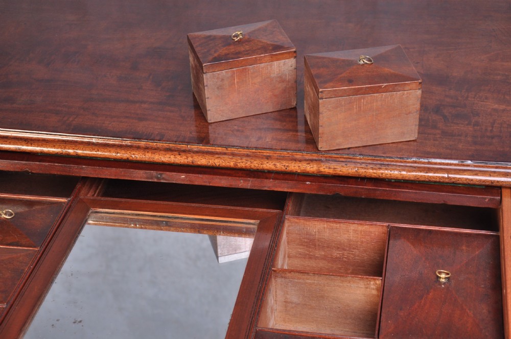 An 18th-century mahogany dressing chest featuring four graduated drawers with brass swan-neck handles and bracket feet. View IX
