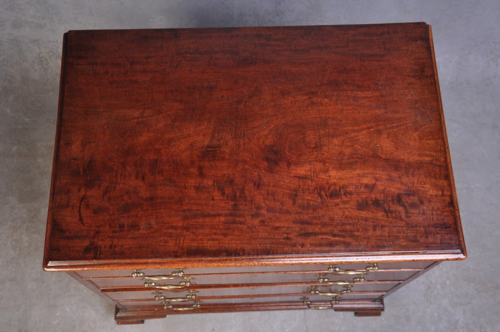 An 18th-century mahogany dressing chest featuring four graduated drawers with brass swan-neck handles and bracket feet. View XI