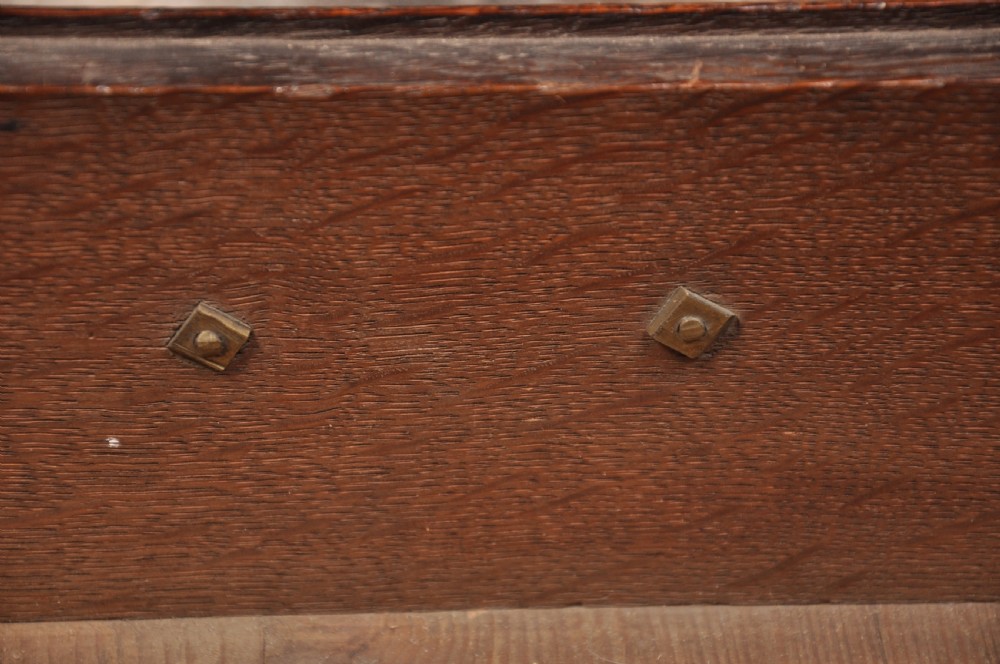 An early 18th-century oak chest on stand featuring two-part construction, multiple drawers with brass drop handles, a shaped apron, and slender cabriole legs. View VIII