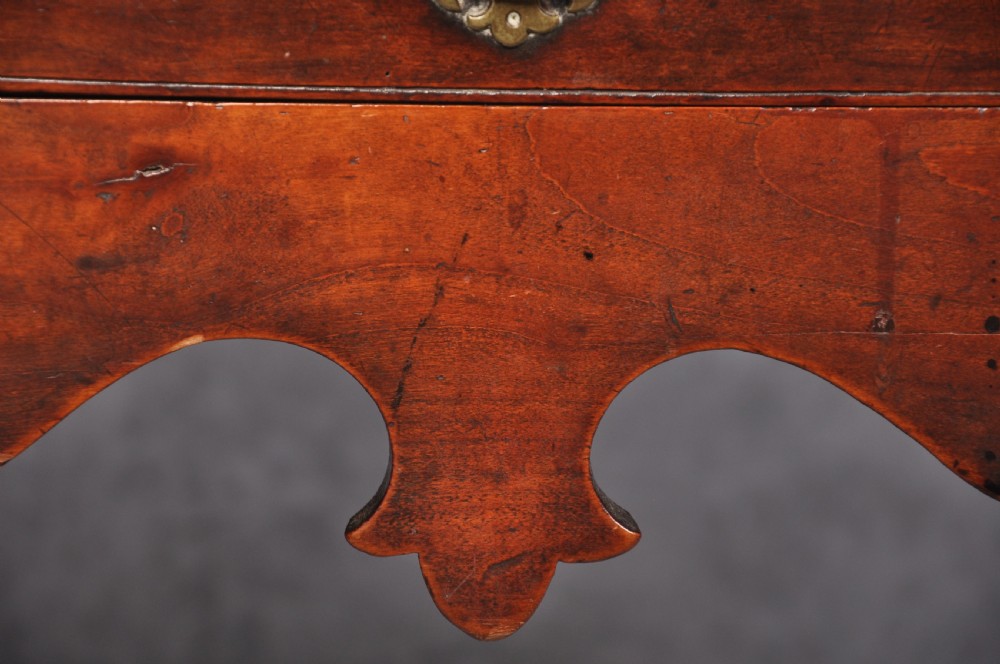 An 18th-century cherrywood lowboy featuring three drawers with brass batwing handles, a shaped apron, and cabriole legs with ball-and-claw feet. View III
