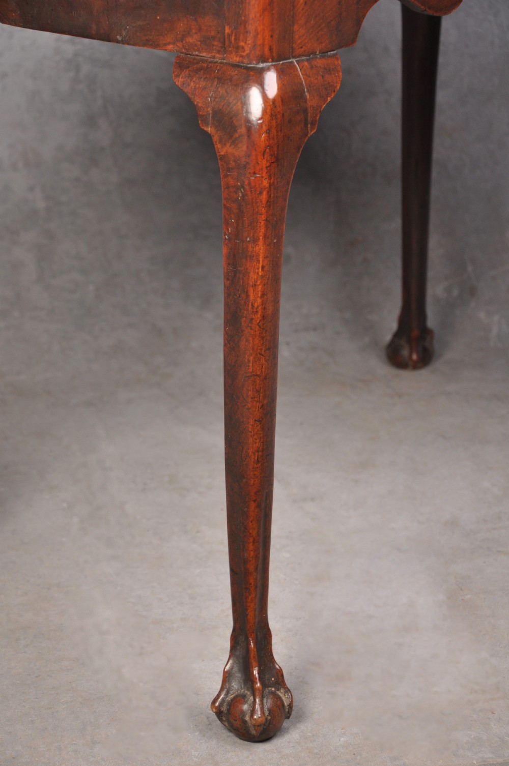 An 18th-century cherrywood lowboy featuring three drawers with brass batwing handles, a shaped apron, and cabriole legs with ball-and-claw feet. View VI