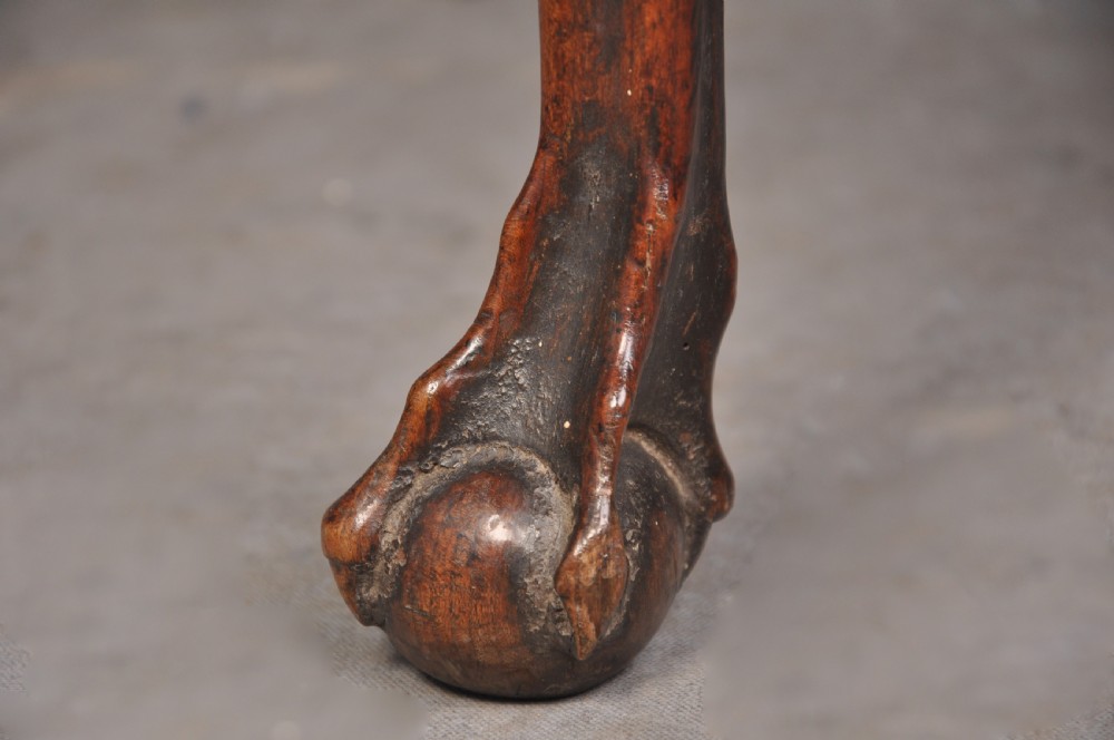An 18th-century cherrywood lowboy featuring three drawers with brass batwing handles, a shaped apron, and cabriole legs with ball-and-claw feet. View VII