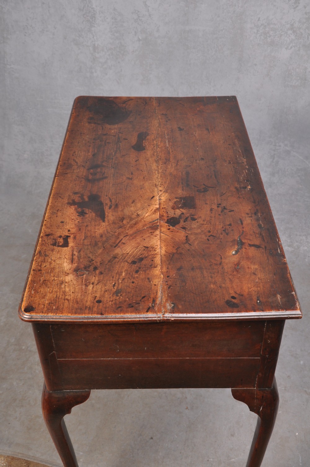 An 18th-century cherrywood lowboy featuring three drawers with brass batwing handles, a shaped apron, and cabriole legs with ball-and-claw feet. View VIII