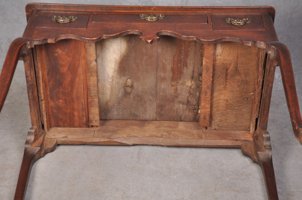 An 18th-century cherrywood lowboy featuring three drawers with brass batwing handles, a shaped apron, and cabriole legs with ball-and-claw feet. View XIV