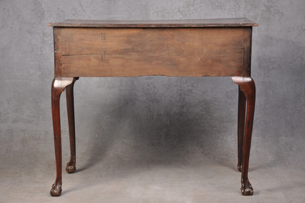 An 18th-century cherrywood lowboy featuring three drawers with brass batwing handles, a shaped apron, and cabriole legs with ball-and-claw feet. View XV