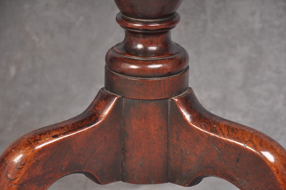 An 18th-century cherrywood tripod table featuring a circular tilt top shown upright, supported by a turned central column and three cabriole legs with pad feet. View III