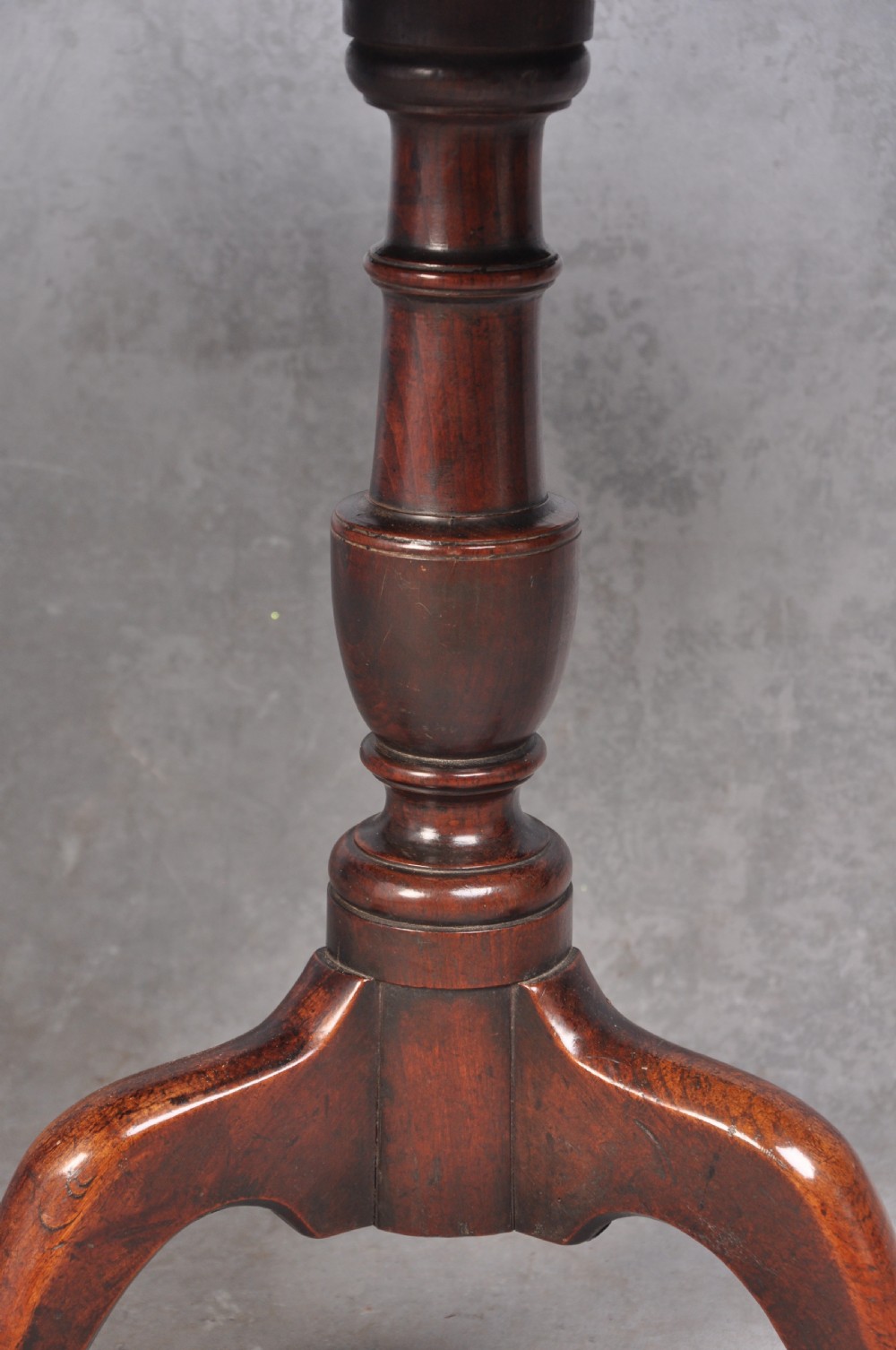 An 18th-century cherrywood tripod table featuring a circular tilt top shown upright, supported by a turned central column and three cabriole legs with pad feet. View IV