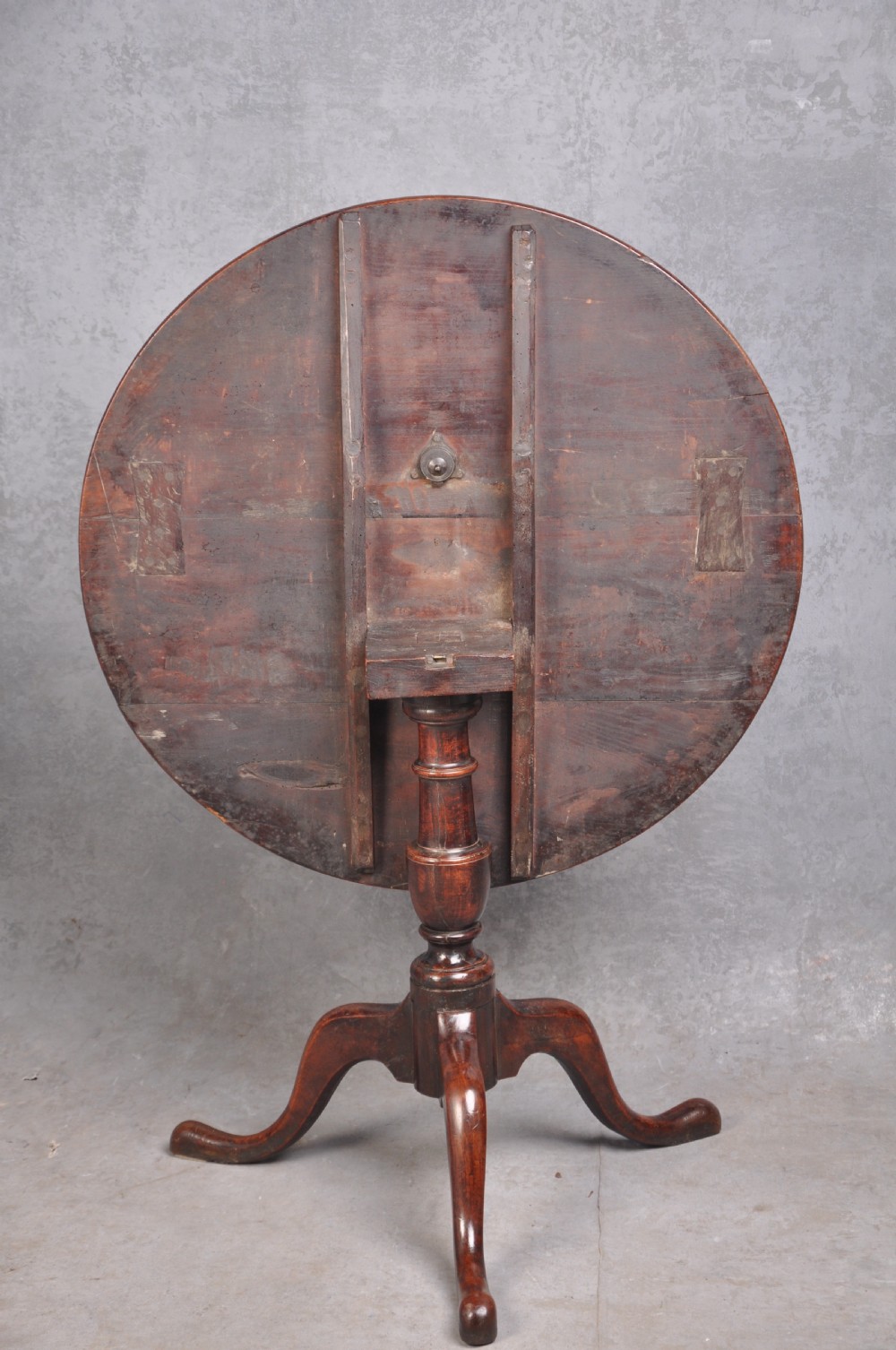 An 18th-century cherrywood tripod table featuring a circular tilt top shown upright, supported by a turned central column and three cabriole legs with pad feet. View XI