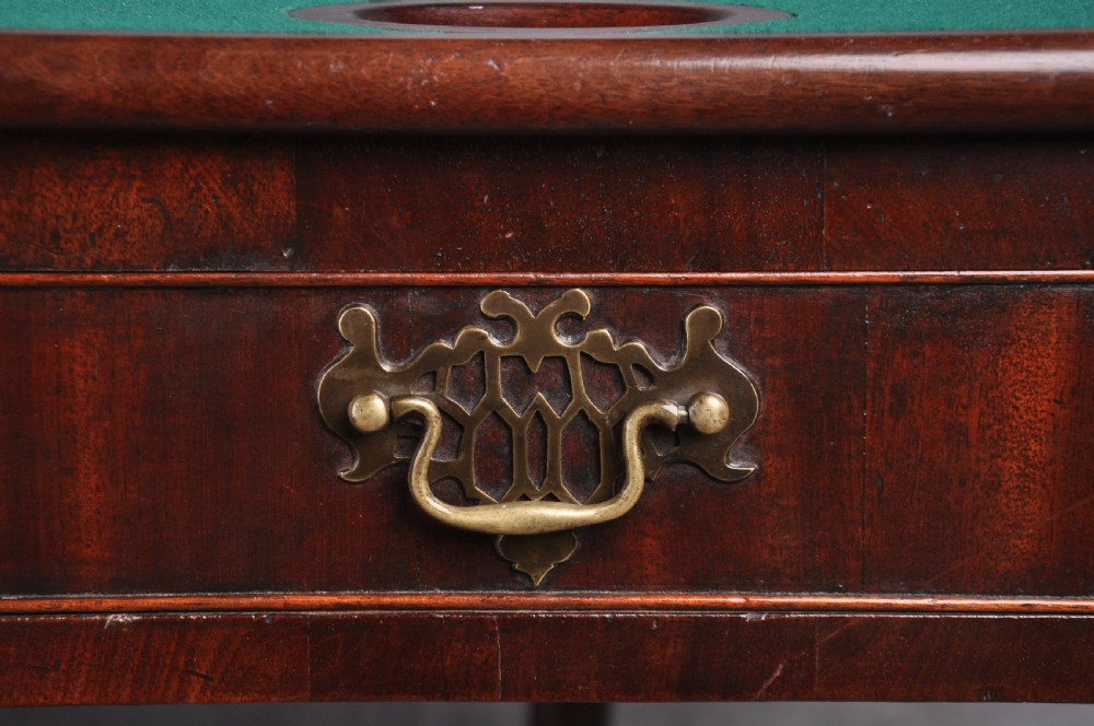 An 18th-century mahogany fold-over card table featuring slender cabriole legs, pad feet, a central drawer with a brass swing handle, and shaped corners. View III