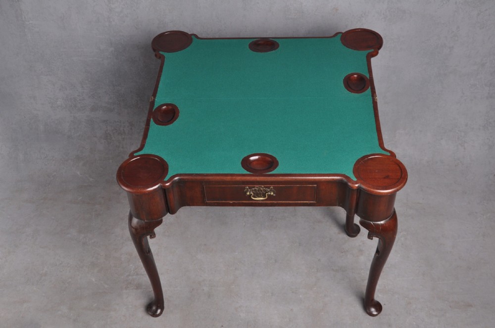 An 18th-century mahogany fold-over card table featuring slender cabriole legs, pad feet, a central drawer with a brass swing handle, and shaped corners. View VI