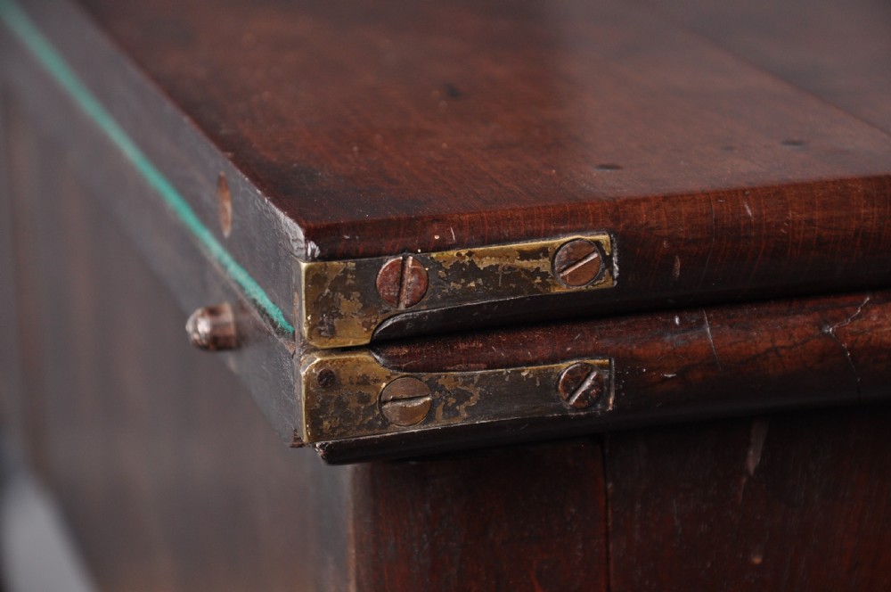 An 18th-century mahogany fold-over card table featuring slender cabriole legs, pad feet, a central drawer with a brass swing handle, and shaped corners. View X