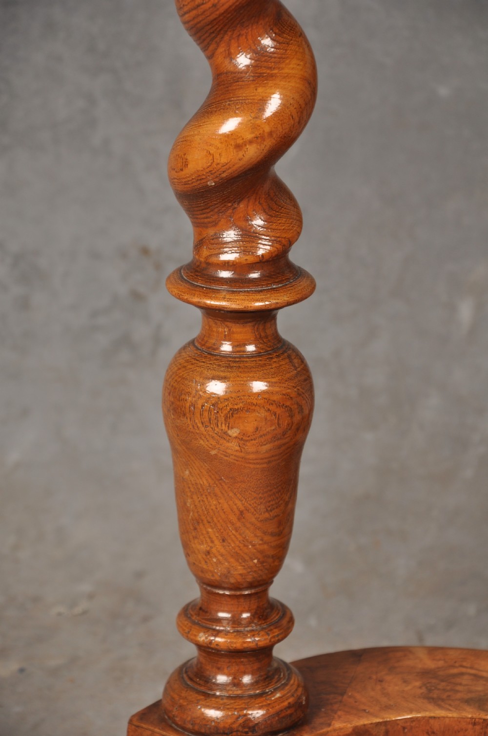 An antique olive wood side table featuring geometric oyster veneering on top, a single drawer with a brass drop handle, four barley twist legs, and a curved stretcher base. View IX